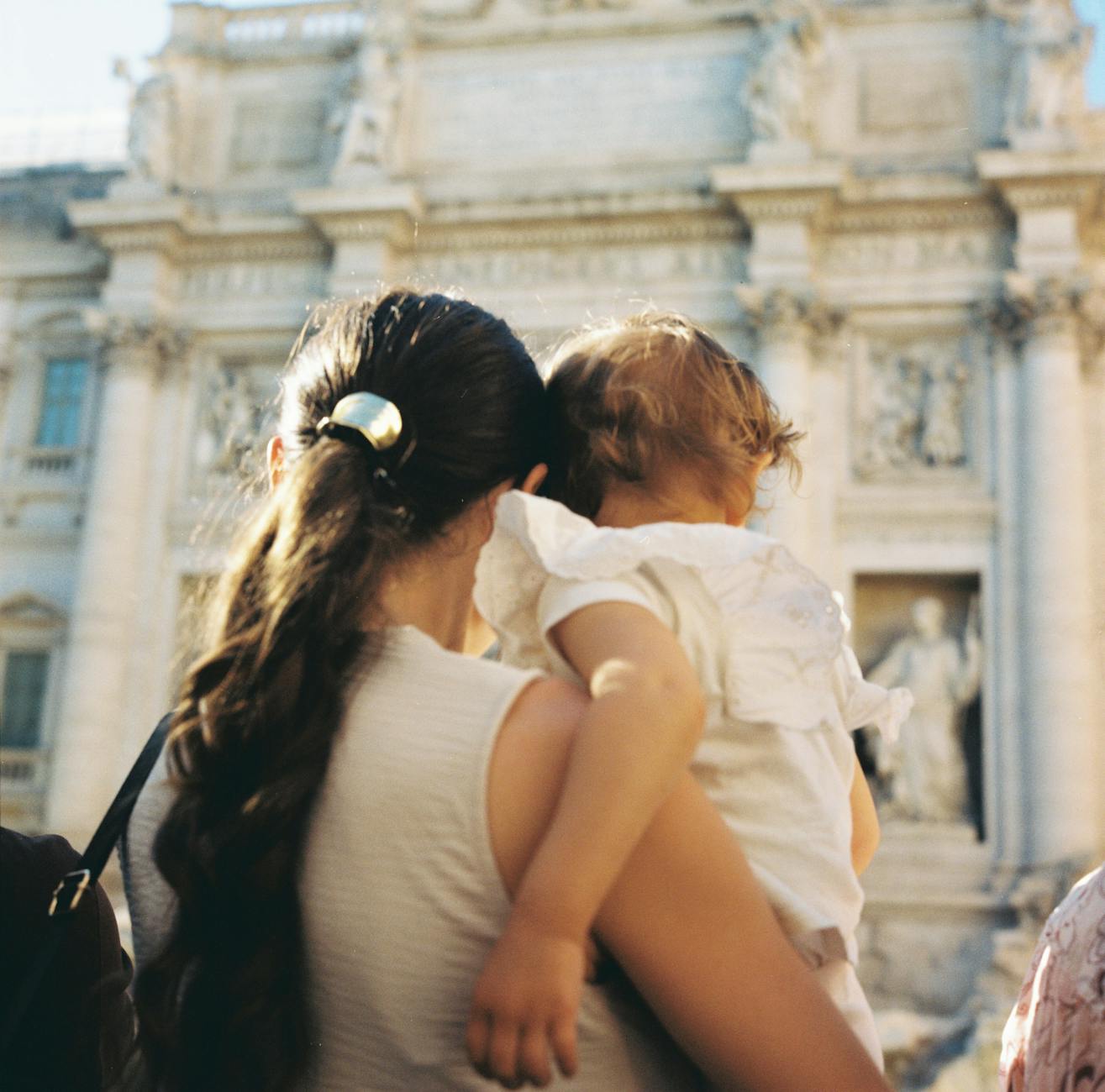 Mama z dzieckiem przy Fontannie di Trevi w Rzymie